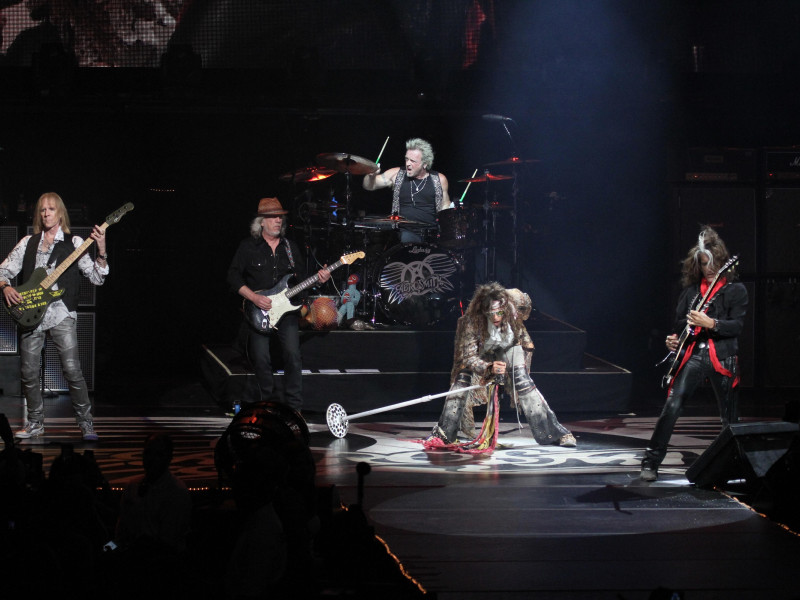 RMR36J Aerosmith is shown performing on stage during a "live" concert appearance.