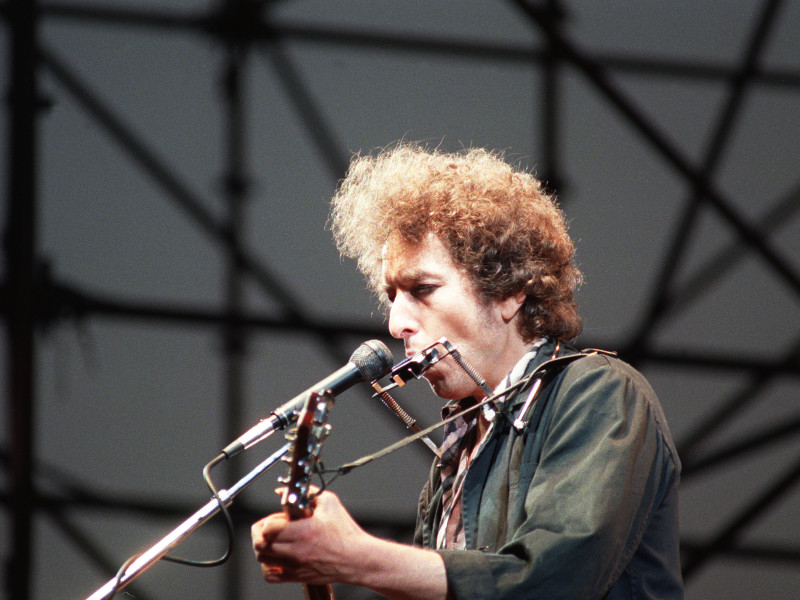 AXAHPP Folk rock star Bob Dylan singing at microphone and playing guitar during concert St James Park Newcastle England