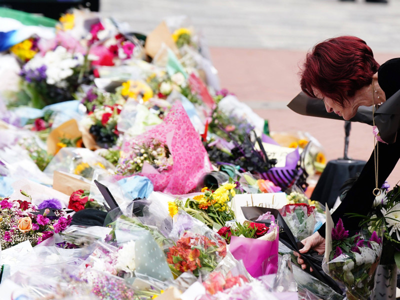 Sharon Osbourne lays flowers at the Black Sabbath Bridge bench on Broad Street in Birmingham in memory of Black Sabbath frontman Ozzy Osbourne, as his body is brought back to his home city for a procession following his death last week aged 76. Picture date: Wednesday July 30, 2025.