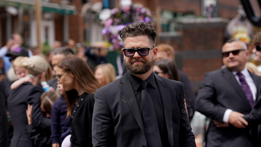 3C5G65P Jack Osbourne views the messages and floral tributes left at the Black Sabbath Bridge bench on Broad Street in Birmingham in memory of Black Sabbath frontman Ozzy Osbourne, as his body is brought back to his home city for a procession following his death last week aged 76. Picture date: Wednesday July 30, 2025.