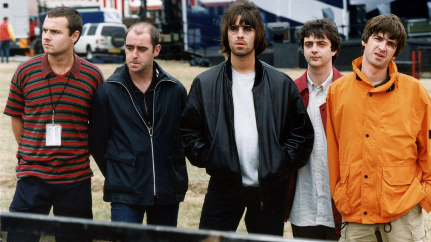 2F1N9P1 File photo dated 07/05/95 of Oasis before their Knebworth Park concert. (left to right) drummer Alan White, rhythm guitarist Paul "Bonehead" Arthurs, lead singer Liam Gallagher, bass player Paul "Guigsy" McGuigan and guitarist and songwriter Noel Gallagher. A gig contract from the early days of rock band Oasis which is set to go for auction at Hansons Auctioneers' music memorabilia sale in Etwall near Derby, Derbyshire, on March 23 with an estimate of ??1,500. Issue date: Tuesday March 9, 2021.